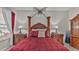 Primary bedroom with a large four poster bed and ensuite bathroom at 7406 Summit Pl, Lakeland, FL 33810