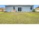Large backyard with grassy area and sliding glass doors at 812 Del Prado Dr, Kissimmee, FL 34758