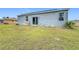 Spacious backyard with grassy area and sliding glass doors at 812 Del Prado Dr, Kissimmee, FL 34758