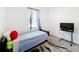 Cozy bedroom with a twin bed, TV, and window at 812 Del Prado Dr, Kissimmee, FL 34758