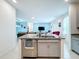 Open concept kitchen with island, granite countertops and living area view at 812 Del Prado Dr, Kissimmee, FL 34758