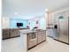 Open kitchen with island, stainless steel appliances, and view of living room at 812 Del Prado Dr, Kissimmee, FL 34758