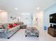 Bright living room, gray sectional sofa, and access to laundry room at 812 Del Prado Dr, Kissimmee, FL 34758