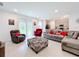 Spacious living room with gray sectional sofa and backyard access at 812 Del Prado Dr, Kissimmee, FL 34758