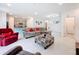 Open concept living room with a gray sectional sofa and kitchen view at 812 Del Prado Dr, Kissimmee, FL 34758