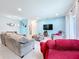 Relaxing living room with sectional sofa and a view of the kitchen at 812 Del Prado Dr, Kissimmee, FL 34758