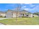 One-story house with a two-car garage and rocking chairs on the porch at 8163 Campbell Crossing Cir, Lakeland, FL 33810