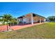 Single story home with covered carport and well-manicured lawn at 1039 Motorcoach Dr, Polk City, FL 33868