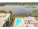 Aerial view showing community pool, lake, and surrounding landscape at 1130 N Lake Parker Ave # A302, Lakeland, FL 33805