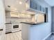 Efficient kitchen with white appliances and gray cabinets at 1130 N Lake Parker Ave # A302, Lakeland, FL 33805