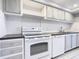 White kitchen with gray cabinets and a built-in dishwasher at 1130 N Lake Parker Ave # A302, Lakeland, FL 33805