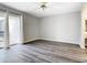 Bright living room featuring wood-look floors and sliding glass doors to balcony at 1130 N Lake Parker Ave # A302, Lakeland, FL 33805