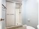 Bathroom featuring tiled shower with sliding glass door and neutral-colored walls at 1130 N Lake Parker Ave # A306, Lakeland, FL 33805