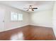 Bright bedroom with hardwood floors, ceiling fan, and a window providing natural light at 1130 N Lake Parker Ave # A306, Lakeland, FL 33805