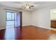 Living room with hardwood floors and sliding glass door to balcony at 1130 N Lake Parker Ave # A306, Lakeland, FL 33805