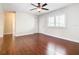 Bright living room with hardwood floors, ceiling fan, and access to hallway at 1130 N Lake Parker Ave # A306, Lakeland, FL 33805