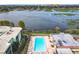 Community pool with lake view and surrounding lounge chairs at 1130 N Lake Parker Ave # A306, Lakeland, FL 33805