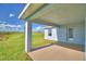 Covered patio with view of grassy backyard at 1214 Tagliamento Ln, Haines City, FL 33844