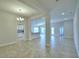 Open concept dining room with tile floors and view into kitchen at 1214 Tagliamento Ln, Haines City, FL 33844