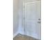 White front door with a two-panel design and brushed nickel hardware at 1214 Tagliamento Ln, Haines City, FL 33844