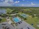 Aerial view showing pool, tennis courts, and parking at 1217 Vista Hills Dr, Lakeland, FL 33813