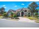 Large house with a double-car garage, brick driveway and well-manicured lawn at 1217 Vista Hills Dr, Lakeland, FL 33813