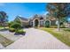 Exterior of a beautiful home with a brick driveway and landscaping at 1217 Vista Hills Dr, Lakeland, FL 33813