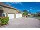 Two-car garage with white doors and a brick paved driveway at 1217 Vista Hills Dr, Lakeland, FL 33813