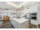 Open kitchen with island, white cabinets, and a large kitchen sink at 1217 Vista Hills Dr, Lakeland, FL 33813