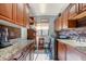 Laundry room with wooden cabinets, granite countertops, and washer/dryer at 1217 Vista Hills Dr, Lakeland, FL 33813