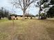 Side yard of the home with mature trees at 122 8Th Se St, Fort Meade, FL 33841