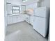 White kitchen with new appliances and tile floor at 122 8Th Se St, Fort Meade, FL 33841