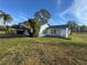 Side view of a single-story house with yard at 127 Colonial Dr, Auburndale, FL 33823