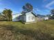 Front view of a single-story house with yard at 127 Colonial Dr, Auburndale, FL 33823