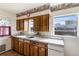 Kitchen with wood cabinets and white appliances at 127 Colonial Dr, Auburndale, FL 33823