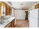 Kitchen with wood cabinets and refrigerator at 127 Colonial Dr, Auburndale, FL 33823