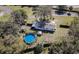 Aerial view showing house, pool, shed, and fenced backyard at 1317 W Belmar St, Lakeland, FL 33815