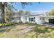 White house with carport, landscaping, and a spacious yard at 1317 W Belmar St, Lakeland, FL 33815