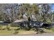 House exterior showcasing a single-story home with mature landscaping and a large tree at 1317 W Belmar St, Lakeland, FL 33815