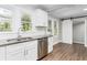 Modern kitchen with white cabinets, granite counters, and stainless steel appliances at 1317 W Belmar St, Lakeland, FL 33815