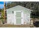 Small, light green storage shed in backyard at 1317 W Belmar St, Lakeland, FL 33815