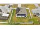 Aerial view of a house with solar panels and a white fence at 1405 Kissimmee Dr, Kissimmee, FL 34759