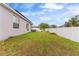 House backyard with a large grassy area at 1405 Kissimmee Dr, Kissimmee, FL 34759