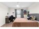 Bedroom with gray upholstered bed and a home office setup at 1405 Kissimmee Dr, Kissimmee, FL 34759