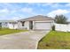 Two-car garage and a well-maintained lawn at 1405 Kissimmee Dr, Kissimmee, FL 34759