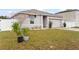 Landscaped front yard with new plants in pots at 1405 Kissimmee Dr, Kissimmee, FL 34759