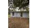 Small gray shed in the backyard with a yard at 1408 28Th Nw St, Winter Haven, FL 33881