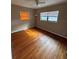 Hardwood floor bedroom with window and ceiling fan at 1408 28Th Nw St, Winter Haven, FL 33881