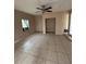 Spacious living room with tile flooring and ceiling fan at 1408 28Th Nw St, Winter Haven, FL 33881