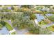 Aerial view of house with pool in a tree-lined neighborhood at 1423 Royal Forest Loop, Lakeland, FL 33811